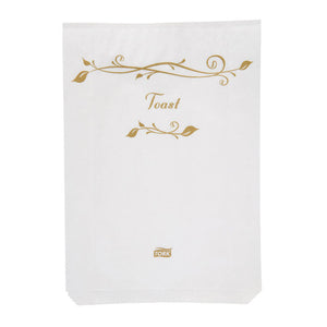 White Tork paper bag printed Toast in gold script with a gold leaf motif above the wording