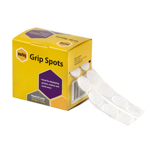 Marbig Grip Spots hook and loop 22mm x 1.8m in a yellow dispenser box with purple panels, round white spots on two backing tapes feeding out of the side