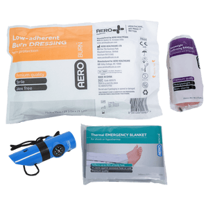 The remote work module contents laid out, including a burn dressing, a conforming bandage, a torch and a thermal emergency blanket