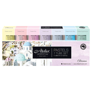 Atelier Interactive Pastels 7 tube set box with seven pastel colour blocks and tubes above a white village photo