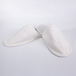 Pair of Compass white closed toe Eco Slippers side by side at an angle, the honeycomb textured upper covering the toes