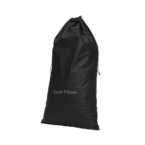 Compass black guest pillow bag standing upright, filled, with Guest Pillow printed in gold-tone letters low on the front and the drawstring tied at the top
