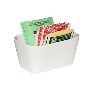 White porcelain Connoisseur sachet holder filled with green and red patterned tea bag envelopes and yellow sugar sachets