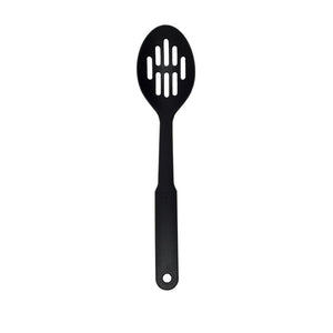 Connoisseur black slotted spoon standing upright on white, oval bowl with two rows of long slots and a hanging hole in the handle