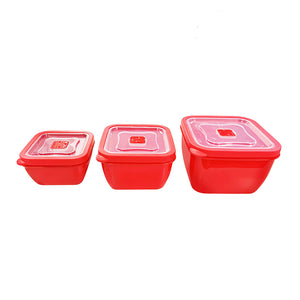 Three red Connoisseur square microwave containers with clear lids, lined up from smallest to largest