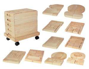 Wooden unit block set of 192 natural rubberwood blocks arranged in four wooden trays stacked on a mobile trolley frame, showing squares, arches, pillars and ramps.