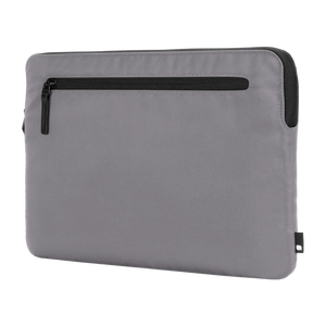 Conte Grey Incase Compact Sleeve in Flight Nylon with a black zippered front pocket, angled view on a plain background