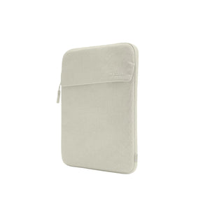 Incase Crosstown Sleeve for 14-inch laptops in Limestone, a light beige-grey, standing upright at a three-quarter angle on a plain white background