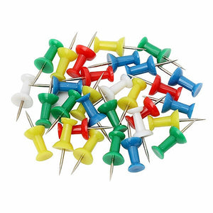 Pile of Marbig push pins with tapered grip heads in green, yellow, red, blue and white and fine metal points, on a white background