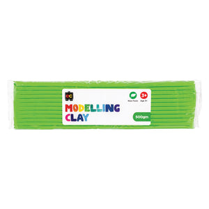 A packaged 500g block of Educational Colours Green Modelling Clay wrapped in clear plastic with a colourful branded label. The packaging highlights the non toxic formula and suitability for children aged 3 years and above, presenting the reusable clay designed for sculpting, arts, crafts and educational modelling activities.