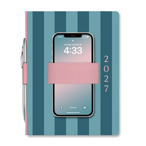 Orange Circle Studio Casey Planner 2027, teal stripes with a phone held in the pink elastic loop and a pen