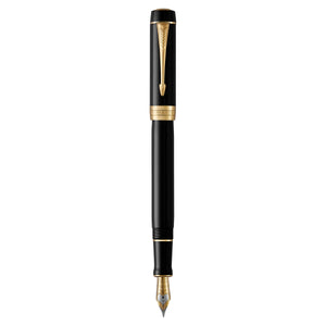 Parker Duofold Classic fountain pen in black resin with gold trims, standing upright and uncapped with a two-tone nib