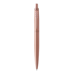 Parker Jotter XL Monochrome ballpoint in matte rose gold standing upright, pink gold clip and click button