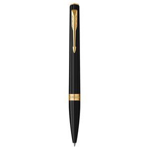 Parker Meridian ballpoint pen in matte black lacquer with gold trims standing upright, showing the arrow clip, centre band and medium tip