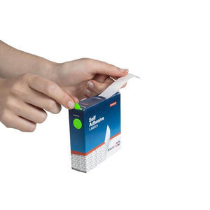 Hand drawing a fluoro green 14mm dot label from the slot of a QuikStik self adhesive labels dispenser box