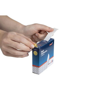 Hand pulling a gold 14mm removable dot label from the slot of a QuikStik self adhesive labels dispenser box