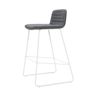 Rapidline Pixel bar high stool in French Navy PU on a white powdercoated tall sled base with a foot rail, product photograph on a plain background showing the ribbed horizontal stitching across the seat and back.