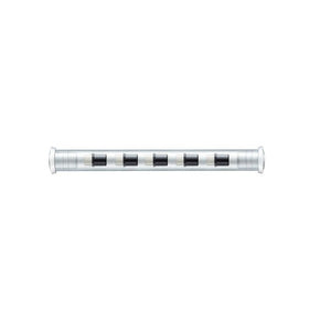 Earlier clear Staedtler tube holding a row of small white eraser plugs, each fitted with a black collar