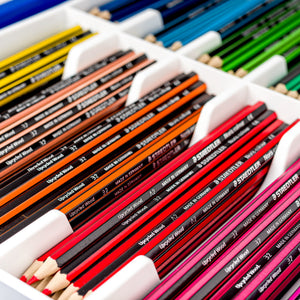 Close view inside the tray: Noris colour pencils grouped by colour in white divided compartments, red, orange, green and blue rows