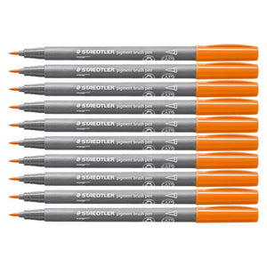 Ten Staedtler pigment brush pens in orange stacked side by side, grey barrels with white Staedtler print and orange caps, brush tips pointing left