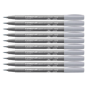 Ten Staedtler 372 pigment soft brush pens in cool grey light stacked in a row, grey barrels with pale grey caps and fine brush tips at left