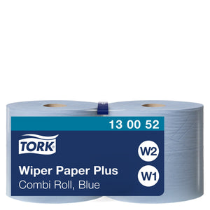 Two light blue Tork wiping paper rolls standing side by side in clear film, navy front label reading Wiper Paper Plus Combi Roll, Blue with code 13 00 52 and round W1 and W2 icons on white.