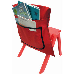 Red Writer chair bag fitted over the back of a red plastic chair, seen at an angle with books and a notebook in its two pockets