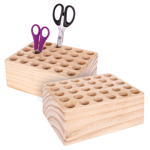 Solid wooden scissors storage block with thirty holes drilled in rows, shown empty on a white background from a front angle.