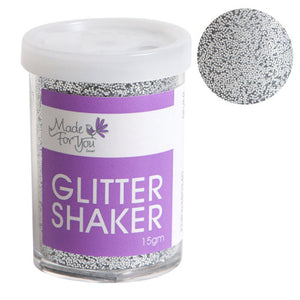 Made For You Glitter Shaker tub filled with silver glitter behind clear sides, purple label marked 15gm under a white lid, beside a round close up of the silver grains