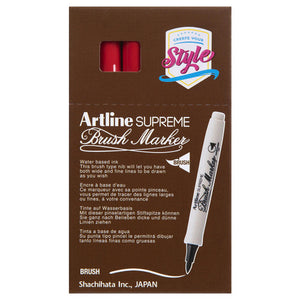 Front of an Artline Supreme Brush Marker box with red markers showing through the window