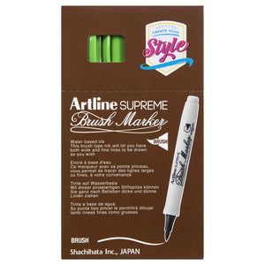 Front of an Artline Supreme Brush Marker box with yellow green markers showing through the window