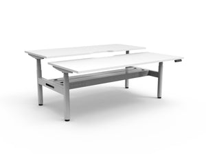 Rapidline Halo Plus electric height adjustable back to back workstation on 70mm diameter round columns, E0 rated Natural White top with a white satin powdercoated frame, fitted ducted cable tray. Rapidline range image supplied for model H+2PCT1275 NW/WS.