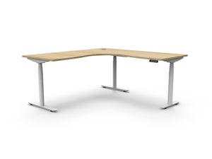 Rapidline Halo Plus electric height adjustable corner workstation on 70mm diameter round columns, E0 rated Natural Oak top with a white satin powdercoated frame. Supplied product image for model H+CNR1P1818 NO/WS.