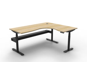 Rapidline Halo Plus electric height adjustable corner workstation on 70mm diameter round columns, E0 rated Natural Oak top with a black satin powdercoated frame, fitted ducted cable tray. Supplied product image for model H+CNRCT1P1815 NO/BL.