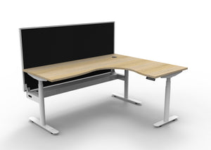 Rapidline Halo Plus electric height adjustable corner workstation on 70mm diameter round columns, E0 rated Natural Oak top with a white satin powdercoated frame, fitted ducted cable tray, 900mm black fabric privacy screen. Supplied product image for model H+CNRWSCT1P1815 NO/WS.