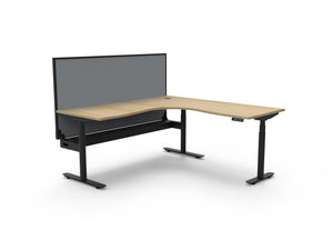 Rapidline Halo Plus electric height adjustable corner workstation on 70mm diameter round columns, E0 rated Natural Oak top with a black satin powdercoated frame, fitted ducted cable tray, 900mm black fabric privacy screen. Supplied product image for model H+CNRWSCT1P1818 NO/BL.