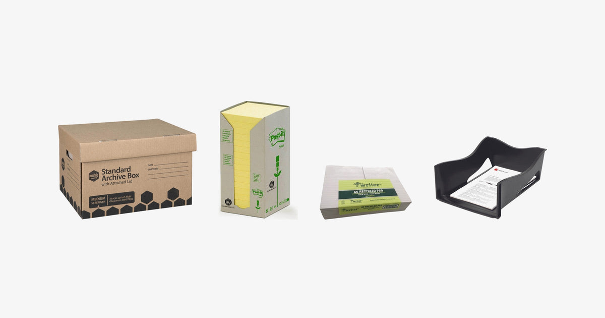 Marbig brown archive box, a Post-it tower of canary yellow notes, a banded pack of Writer A5 ruled pads and a black Marbig jumbo document tray on a light grey background