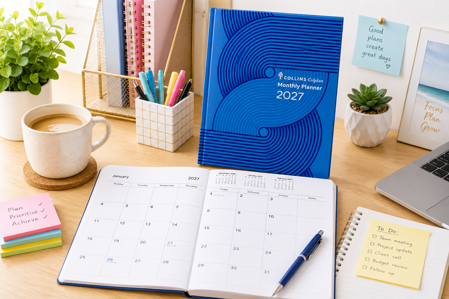 Spiral day to page diaries for 2026, 2027 and 2028 on a bright office desk with an open planner, pen and organised desk accessories.