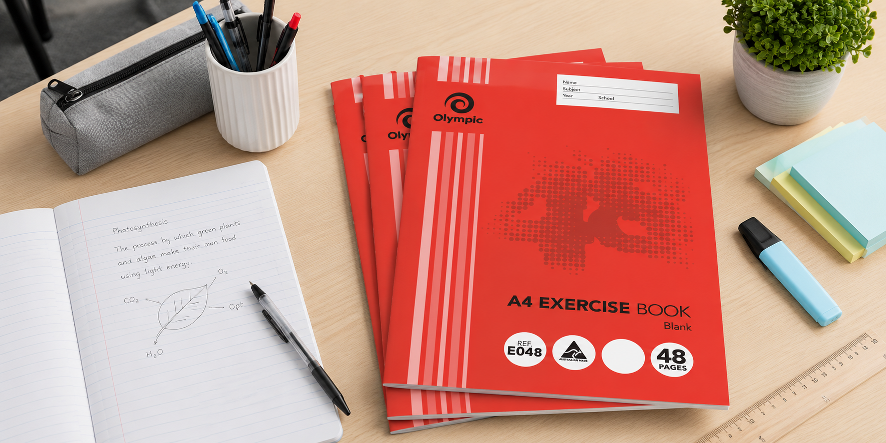 A4 exercise books on a tidy study desk with pens, stationery and an open notebook for school notes and classroom work.