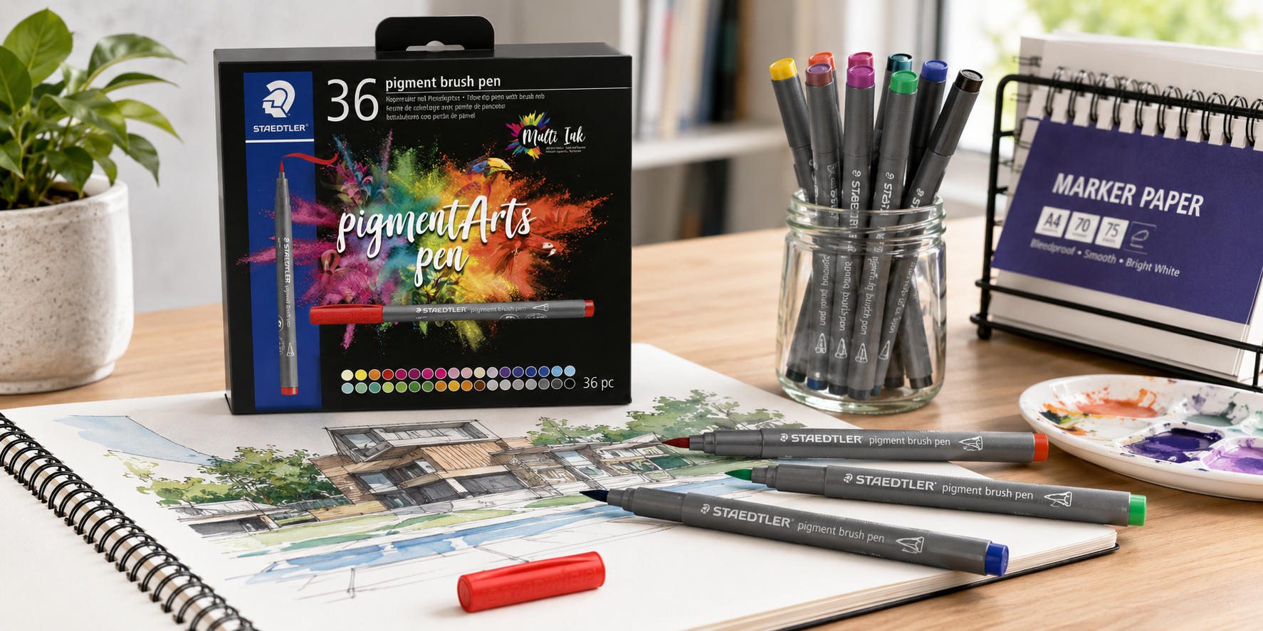 Art markers, marker paper and colourful artwork arranged on a bright modern creative studio desk.