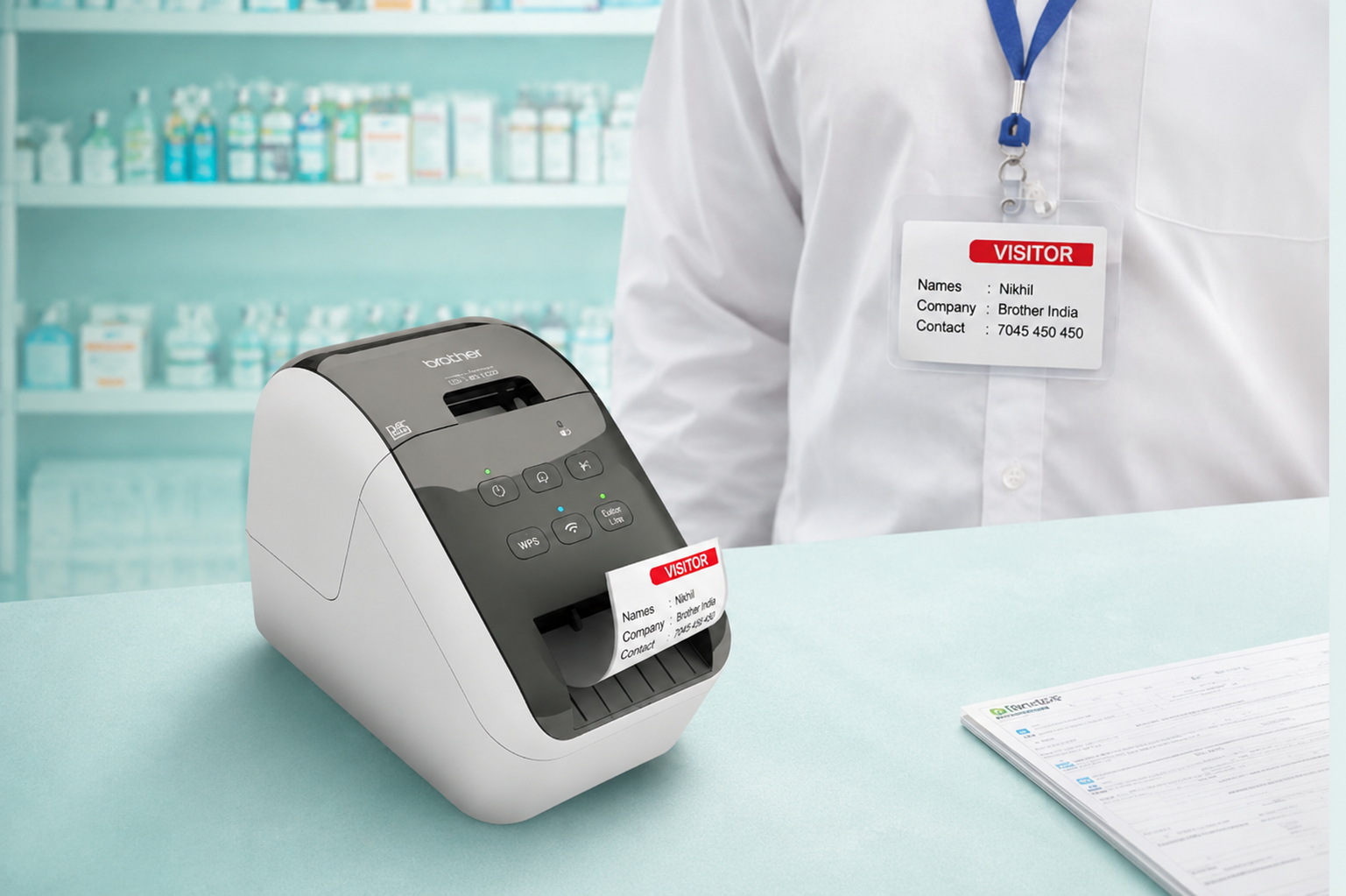 Brother label printer producing visitor labels at a clean clinic reception counter with staff identification badge.