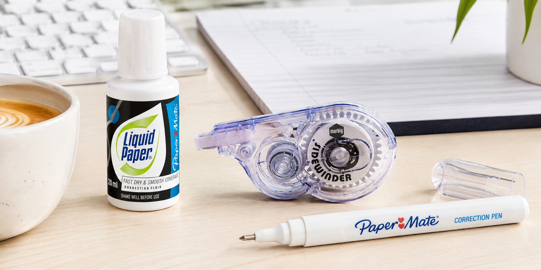 Correction fluid, correction tape and correction pen arranged on a bright modern office desk.