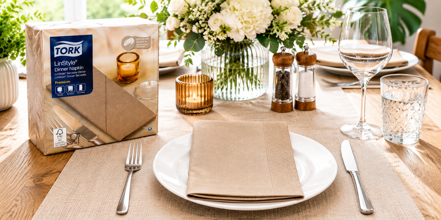 Tork dinner napkins displayed on a bright modern dining table with a folded paper napkin, formal place setting and hospitality tableware.
