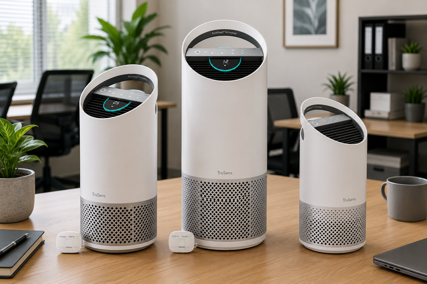 Trusens air purifiers arranged on a modern office table with air quality sensors, plants and workstations in the background.