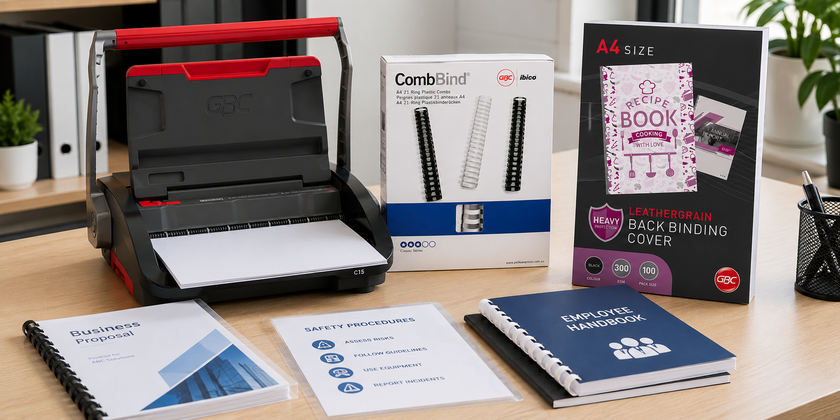 Office binding supplies arranged in a professional print room with a comb binding machine, binding combs, covers and finished documents.
