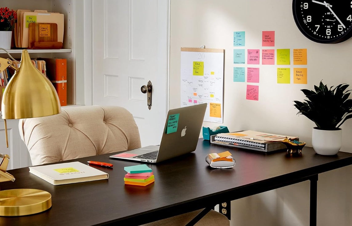 Pop up sticky notes used around an organised admin desk for fast reminders, messages and task tracking.