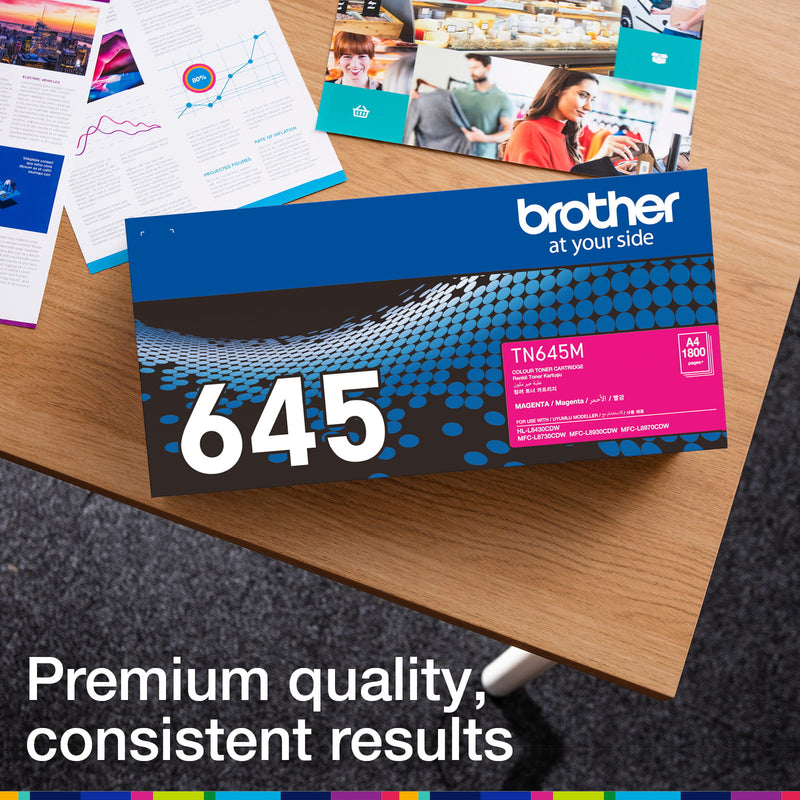 Brother TN-645M retail carton photographed beside printed colour documents
