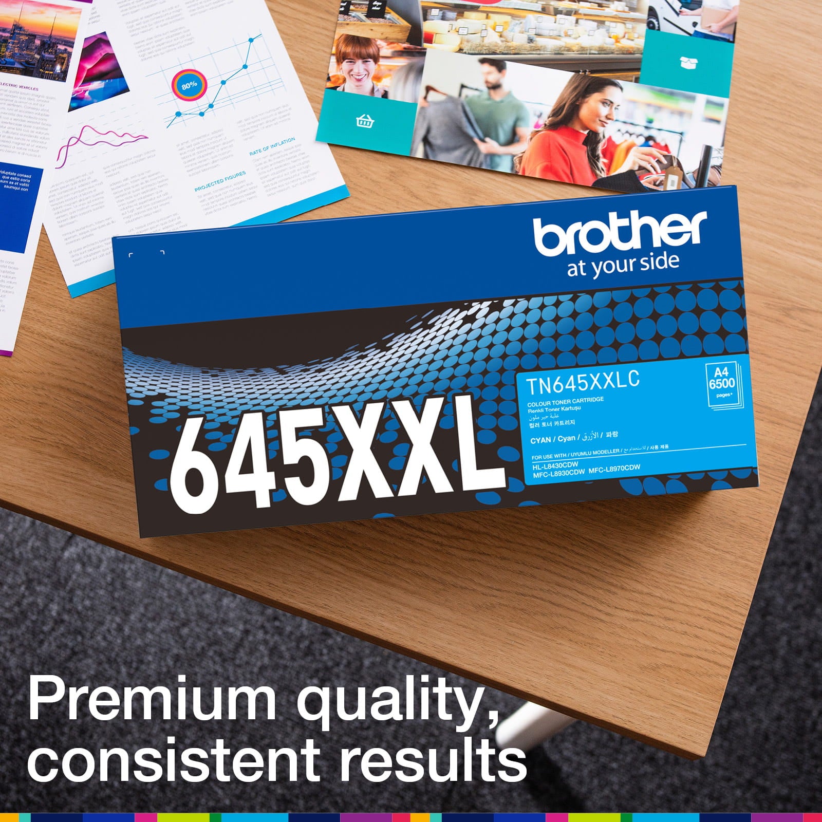 Brother TN-645XXLC retail carton photographed beside printed colour documents