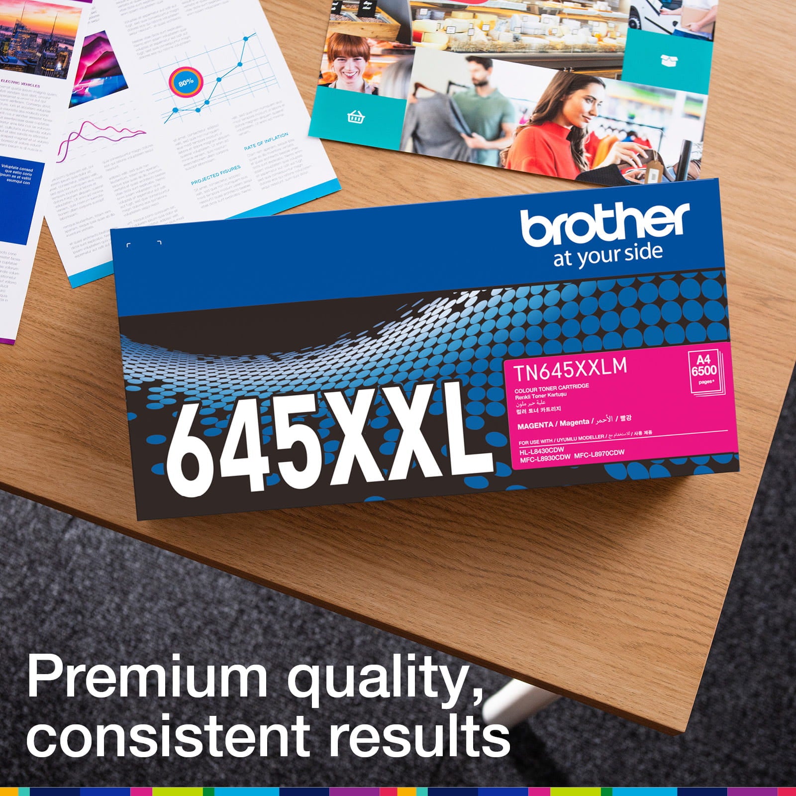 Brother TN-645XXLM retail carton photographed beside printed colour documents