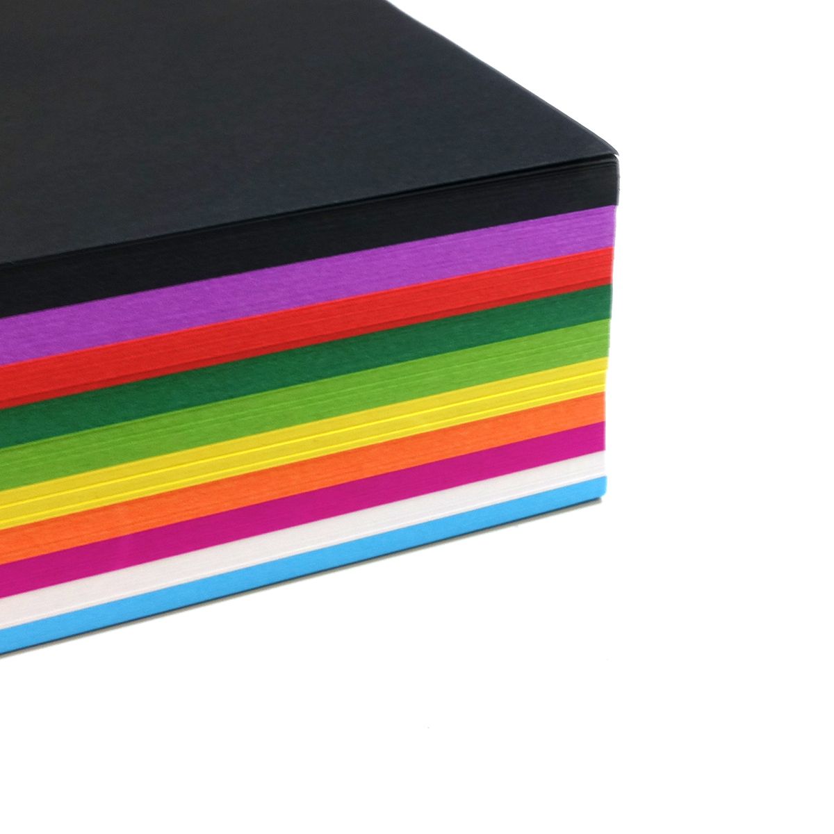 Corner view of a stack of Quill A4 assorted cover paper, black on top over purple, red, green, yellow, orange, pink, white and blue layers